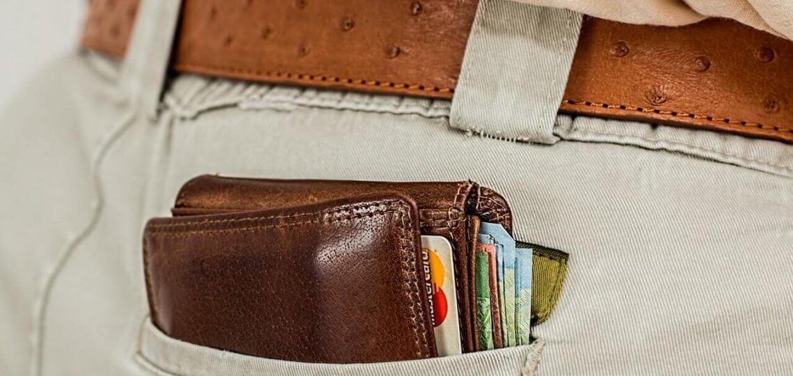 brown wallet full of cash